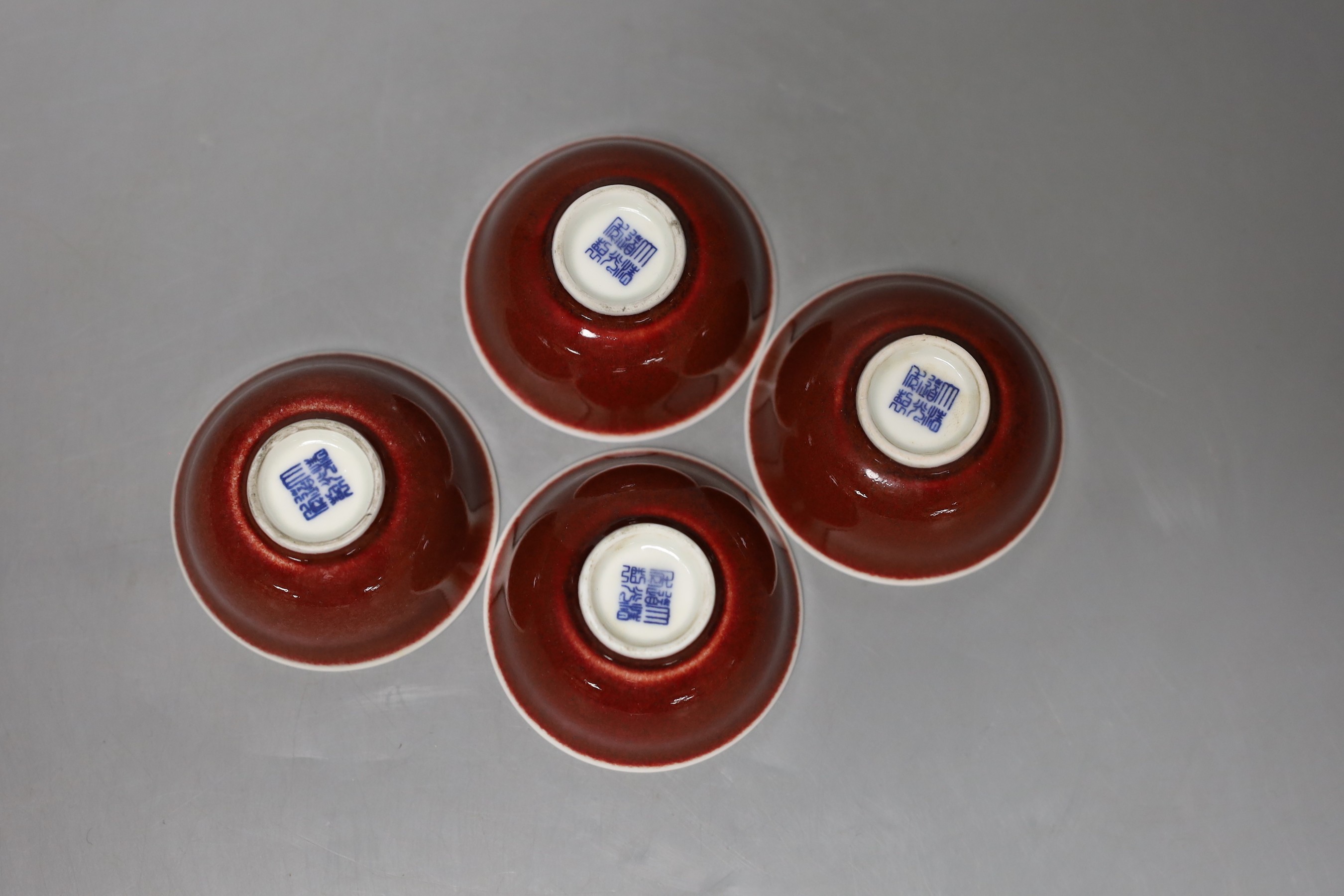 A set of four Chinese ox blood bowls, marks to base, 3.5cm high